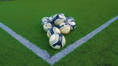 A bag of footballs left on the astro turf pitch reading for a training session at Ballina Town FC.